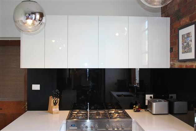 image of beautiful high-gloss handleless kitchen cupboards